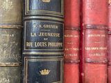 a lot of old books on a shelf in a library
