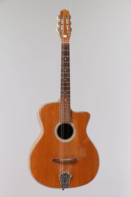 an old guitar hanging on a wall in a room