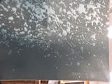 a black and white picture of a painting on a easel