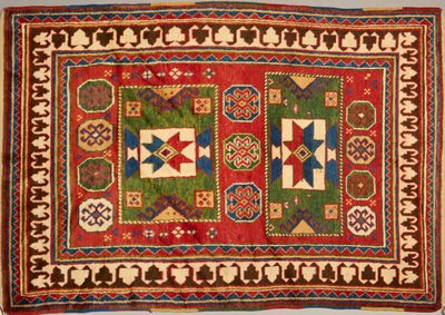 a red and green rug with geometric designs on it