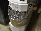 a mixer that is sitting on a cart in a room