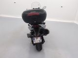 a motorcycle parked in a room with a license plate on the back of it