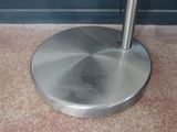 an image of a metal umbrella stand on the ground
