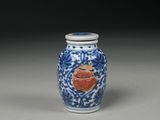 blue and white vase with a red heart on it on a table