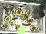 many different types of brass bells in a basket