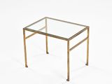 a brass coffee table with a glass top on a white background