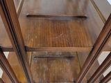 a wooden shelf that has three shelves on top of it