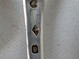 a silver spoon with a handle on a table