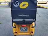 a yellow and black scooter parked on the side of the road
