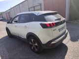 the rear end of a white suv parked in front of a building
