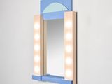 a mirror that has lights on it in the corner of a room
