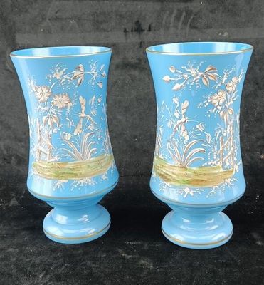 two vases that are sitting on a black surface