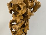 sculpture of a piece of rock with holes in the middle of it