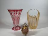 three glass vases sitting next to each other on a table