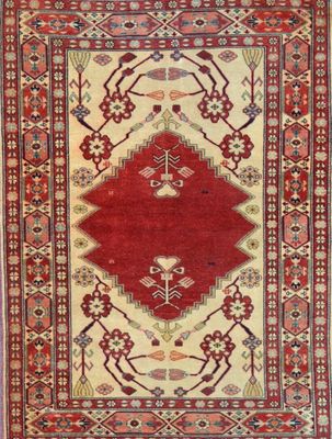 a red and beige rug with a diamond design on it