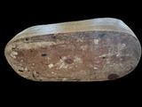 a wooden shoe that has been worn on a black background