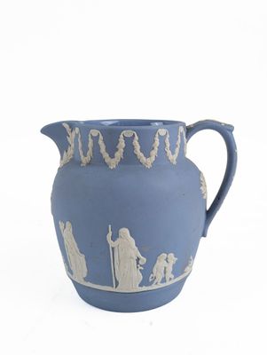 a blue vase with a picture of people on it
