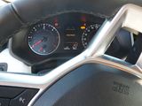 dashboard of a car with a speedometer, gauge and steering wheel