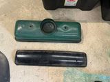a green speaker and a black speaker on the floor