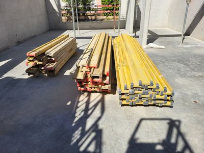 plusieurs pièces de bois sont empilées dans un entrepôt