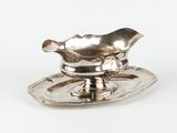 a silver plate with a saucer and a spoon on it