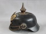 an old helmet with a bird on it sitting on a white surface