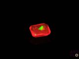 a red light in the middle of a black background