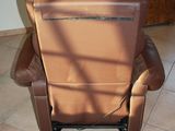 a brown recliner that is sitting in a room