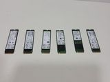 a close up of four memory modules on a white surface