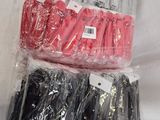 several pairs of scissors are wrapped in plastic bags on a table