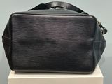 a black louis vuitton bag sitting on top of a white box