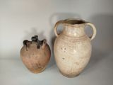 two vases sitting next to each other on a table