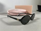 a pair of sunglasses sitting on a table next to a pink case