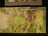 two paintings on the wall of a room one is of a house and the other is of a tree