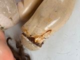 a woman laying on the floor next to a wooden dummy