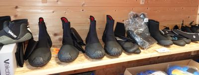 Plusieurs paires de chaussures sont alignées sur une étagère dans une pièce