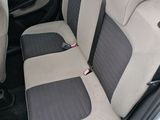 the back seats of a silver car with black trims
