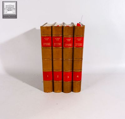 three brown books sitting on top of each other on a white surface