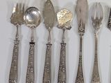 a lot of silver spoons and forks on the table