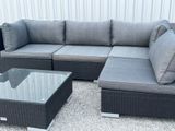 an image of a couch and coffee table in a yard