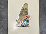 an old book with a picture of a man carrying a surfboard