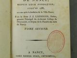 an open book with a stamp on it sitting on a table