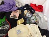 a picture of a pile of clothing and a hat on a bed