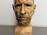 a close up of a sculpture of a man ' s head on a table
