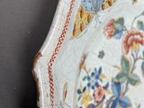 an ornately decorated plate with flowers and birds on it