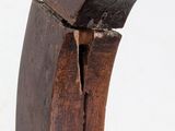 a close up view of a wooden chair with a curved back