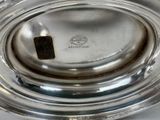 a close up of a silver plate on a table
