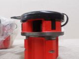 a small red object on the table next to a plastic bag