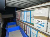 many boxes that are sitting on the shelves in the room