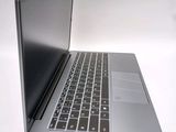a silver laptop with a black keyboard on a white surface